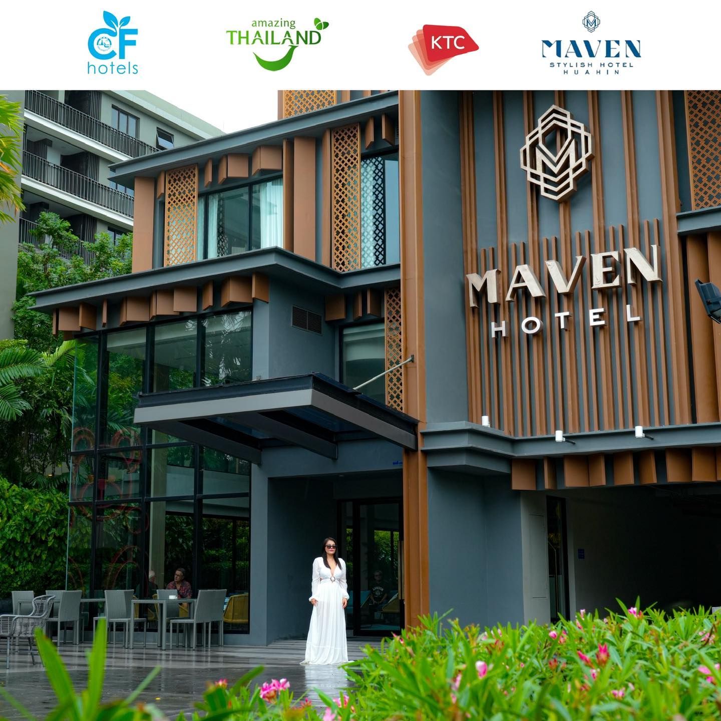 A woman in a white dress stands in front of the maven hotel huahin