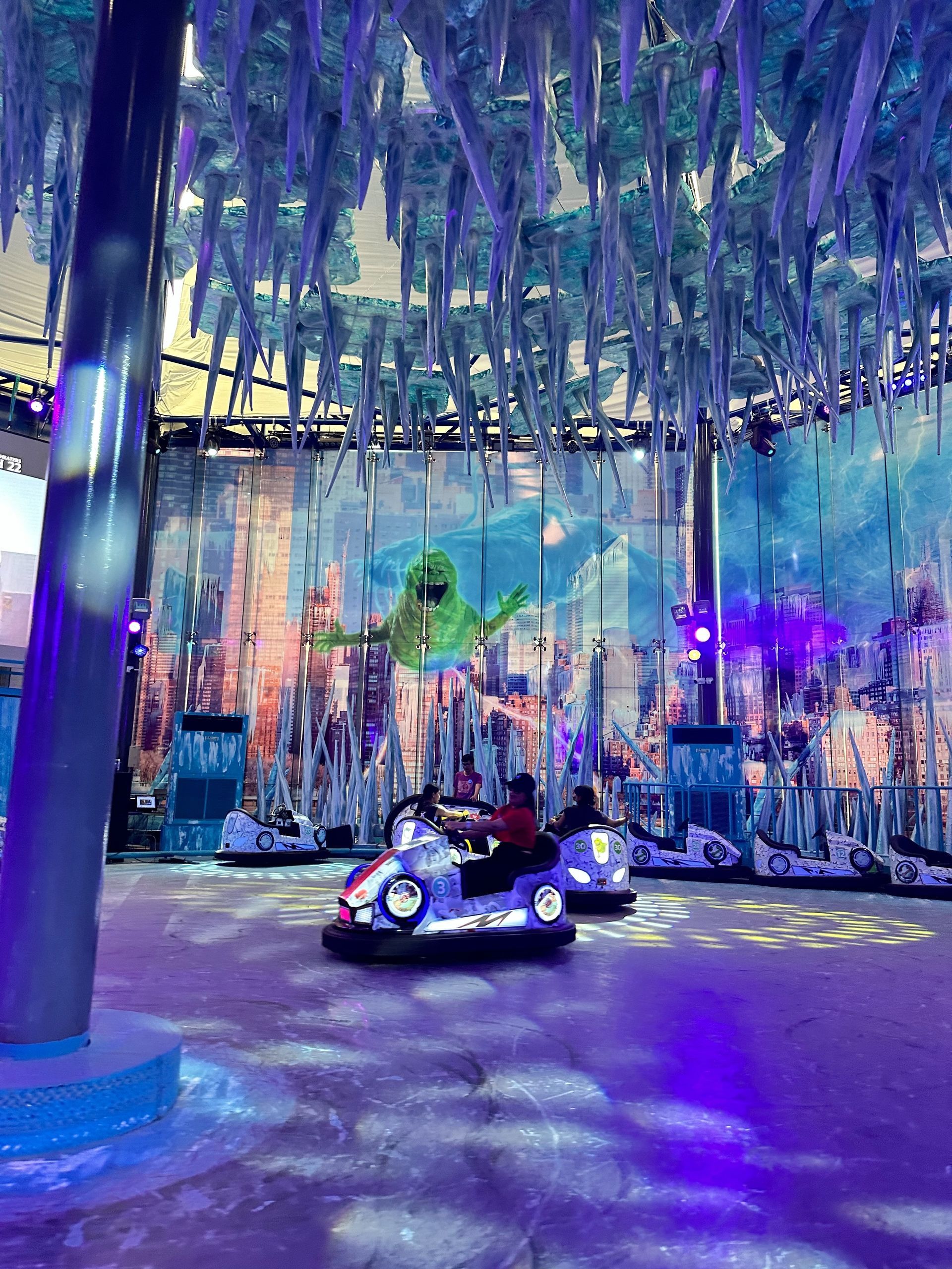 A group of people are riding bumper cars in an amusement park.