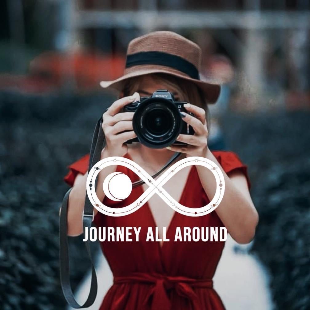 A woman in a red dress is taking a picture with a camera ..