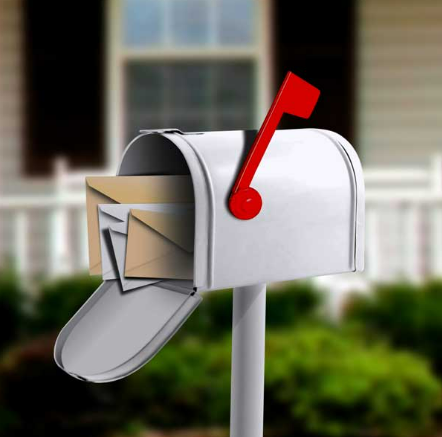 A white mailbox with a red flag on it