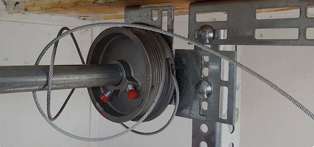 Broken torsion spring above residential garage door