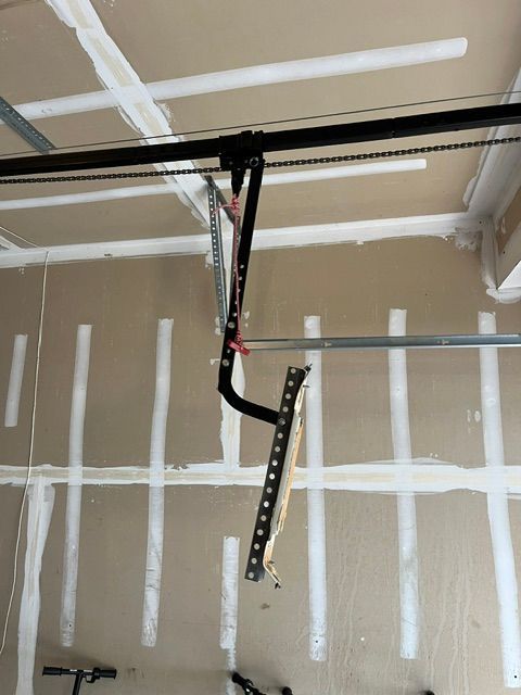 Broken garage door opener arm on residential garage door