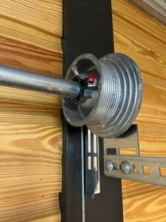 Broken torsion spring above residential garage door