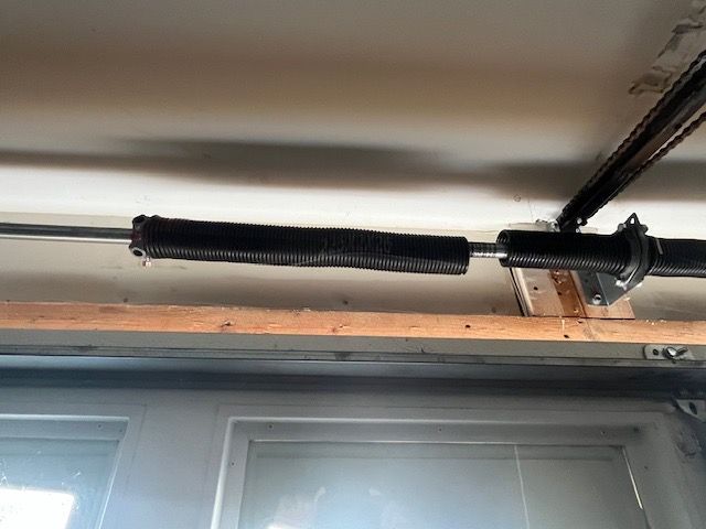 Broken torsion spring above residential garage door