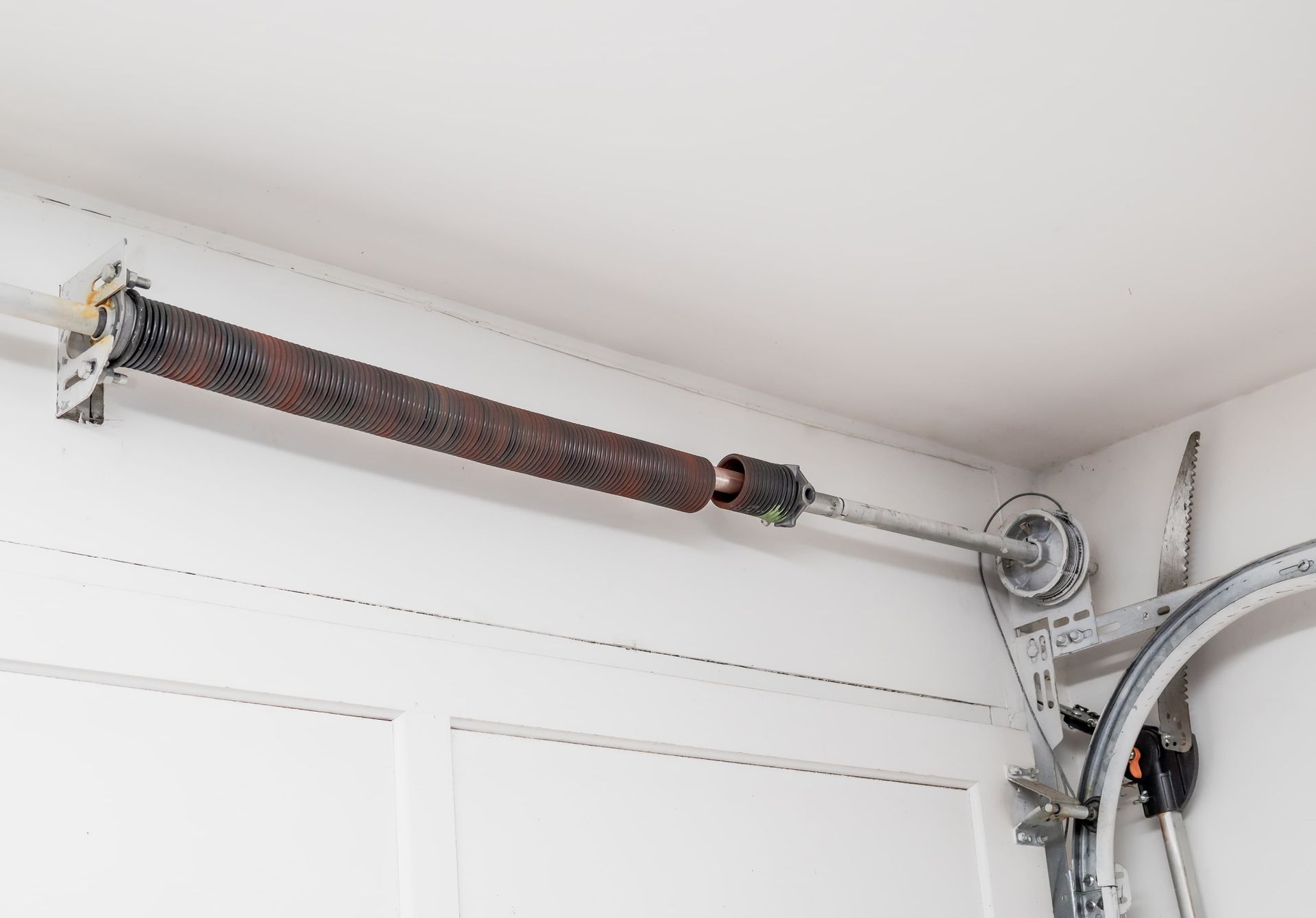 Broken torsion spring above residential garage door