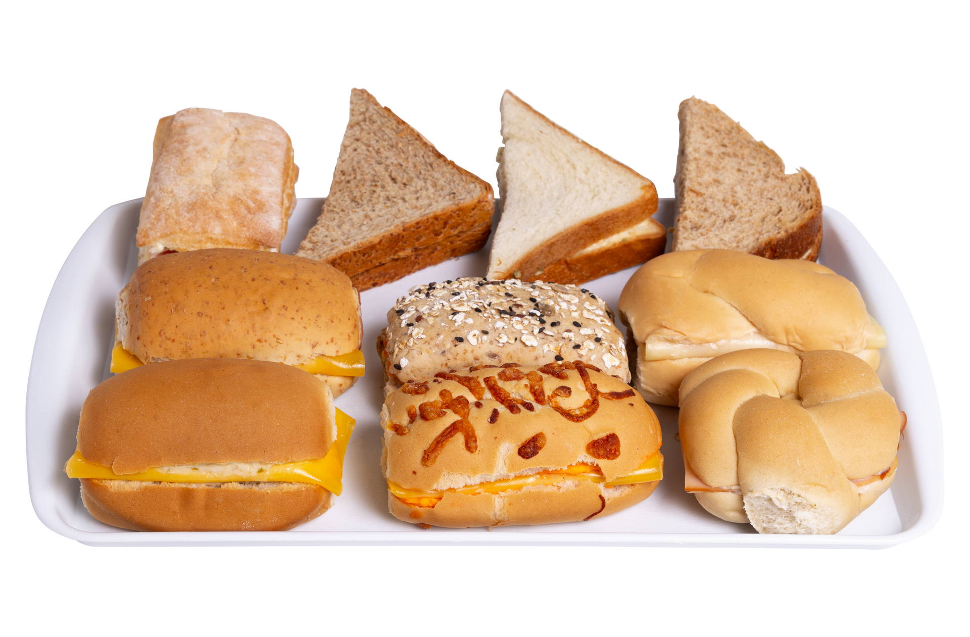 Three sandwiches are sitting on a glass tray on a table.
