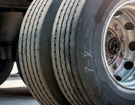 A close up of a truck 's tires and wheels.