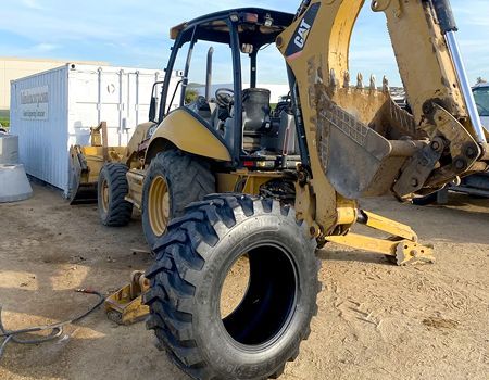 A bulldozer with a tire on the back of it.