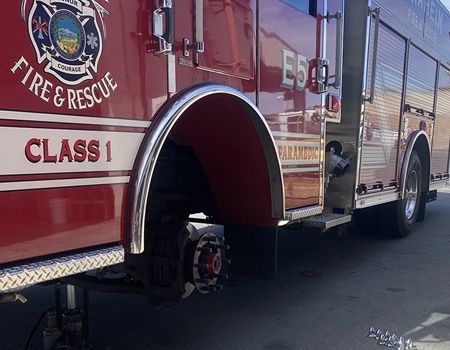 A red fire truck is parked on the side of the road.