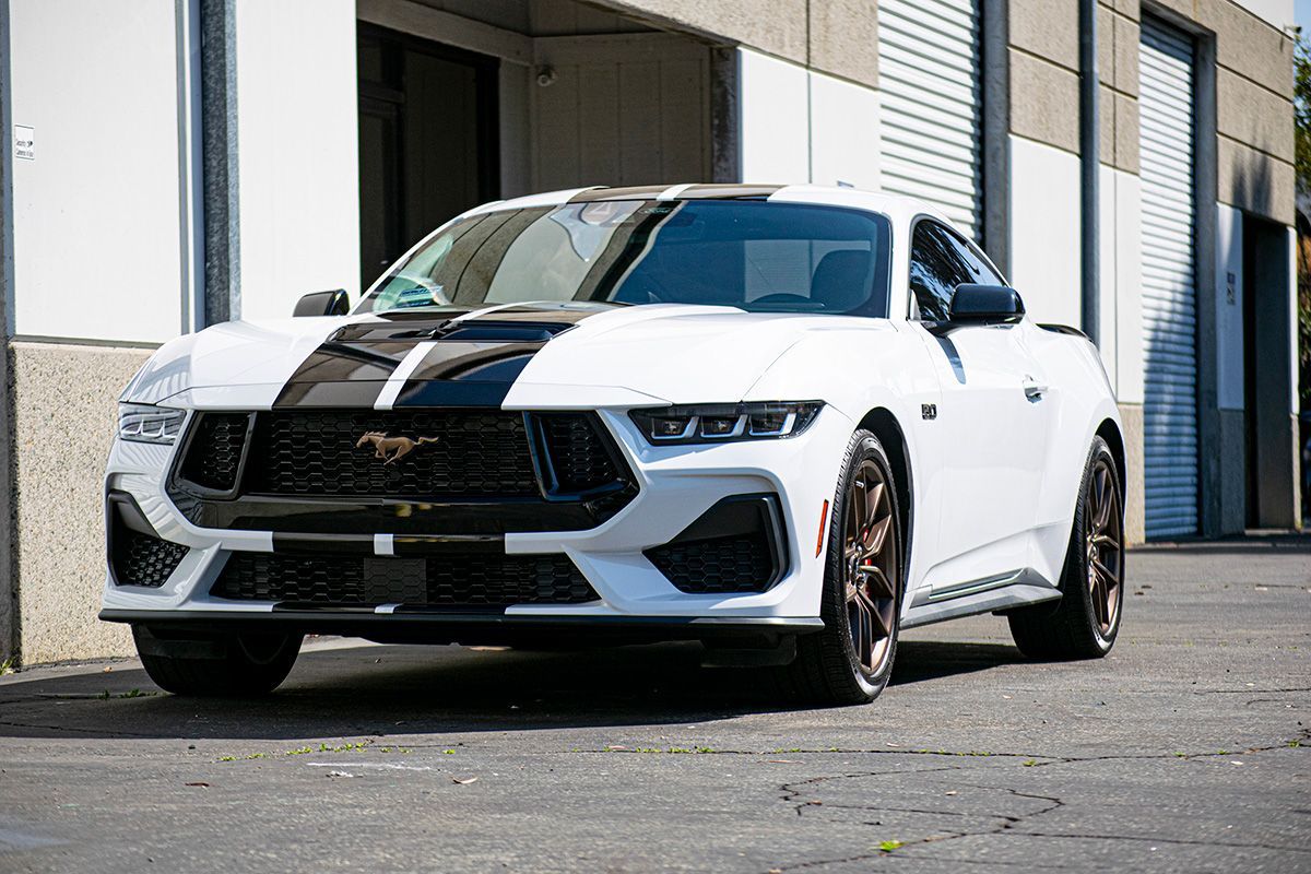 A close up of the hood of a car with a hood scoop.