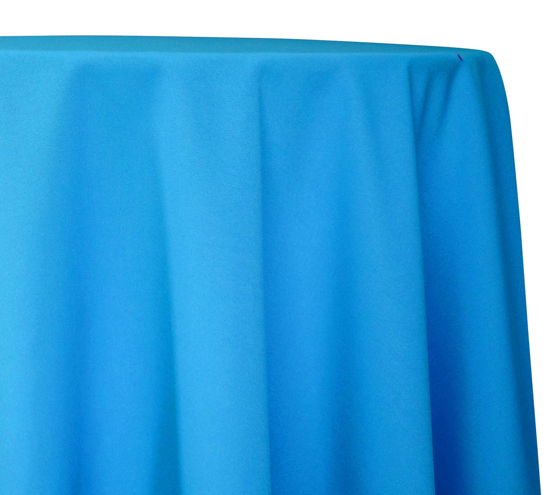 Blue draped fabric hanging over a table edge