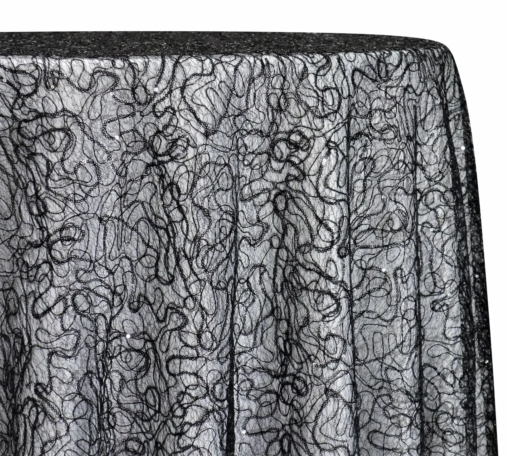 Close-up of a gray textured fabric with a black abstract pattern and dark trim