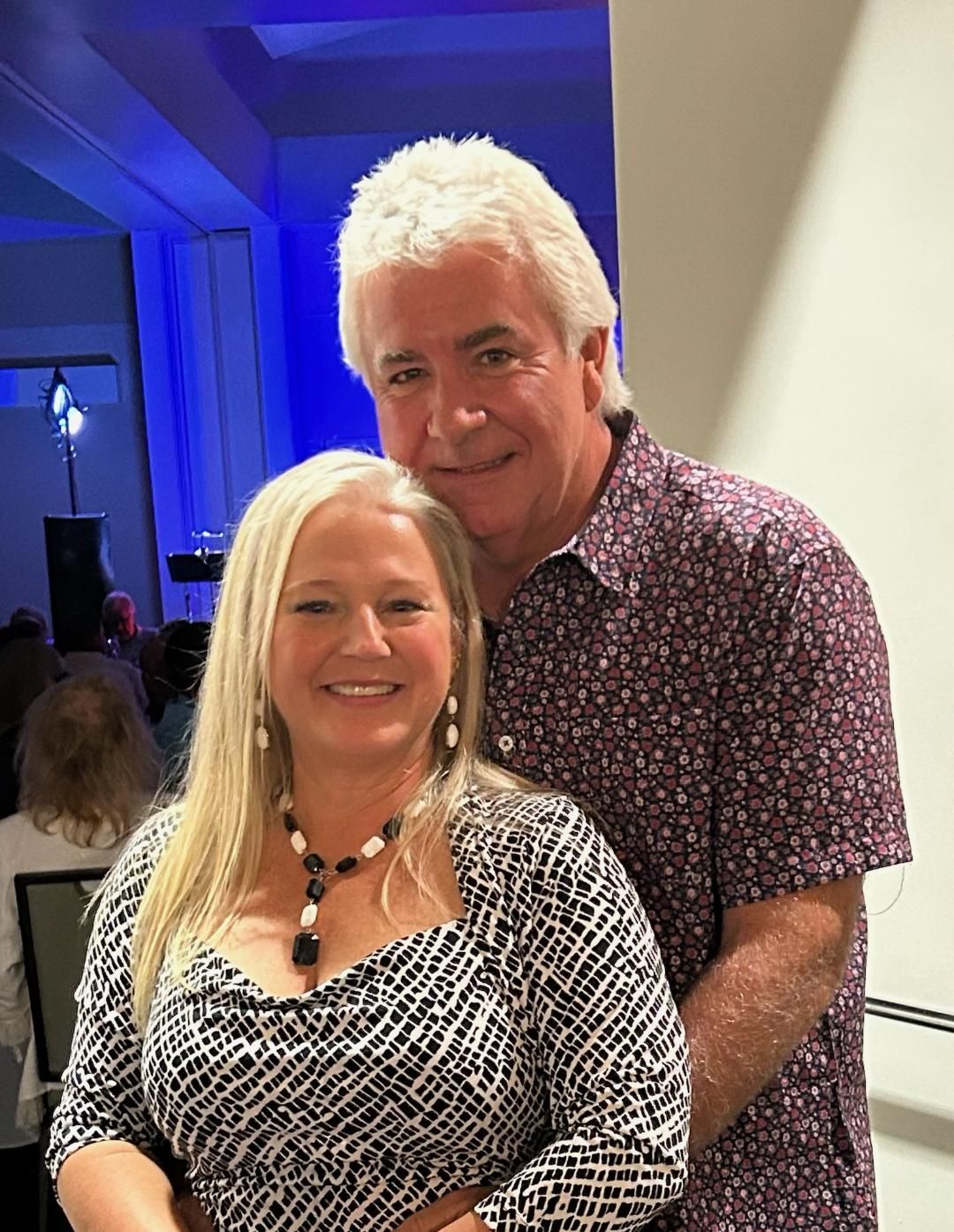 A man and a woman are posing for a picture together.