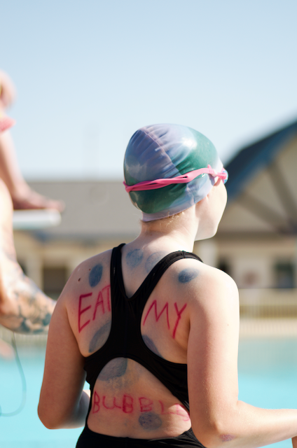 Person in a swimsuit by a pool with 