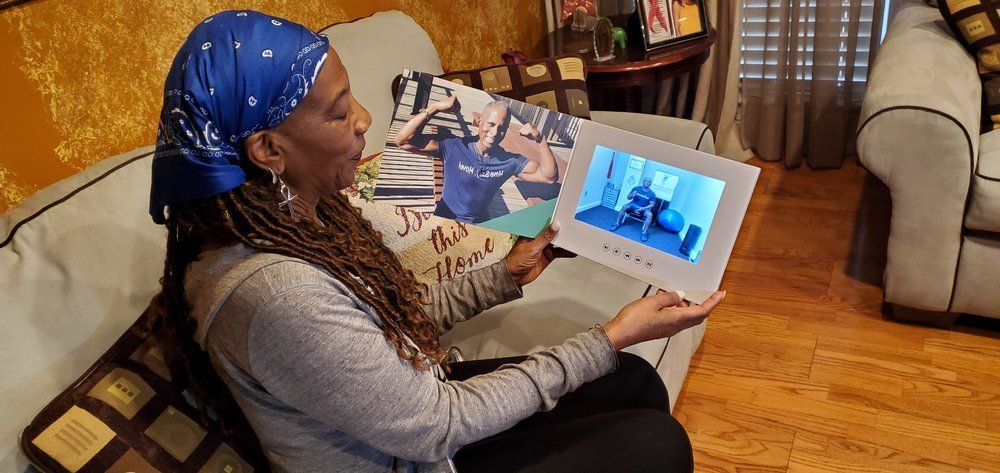 Person seated on a couch, holding open a book with blue-toned images inside