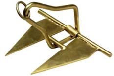 A close up of a brass anchor on a white background.