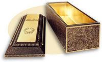 Gold coffin with matching lid, decorated with ornate patterns, shown open on a white background