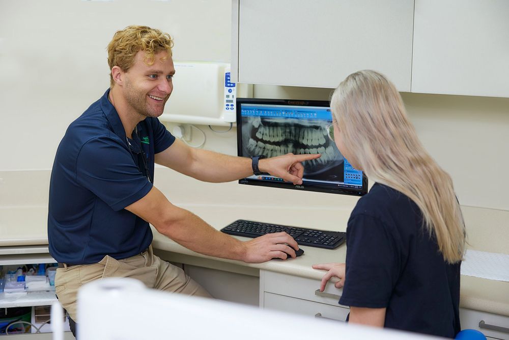 Dentist Speaking to Patient Before Dental Implant Procedure