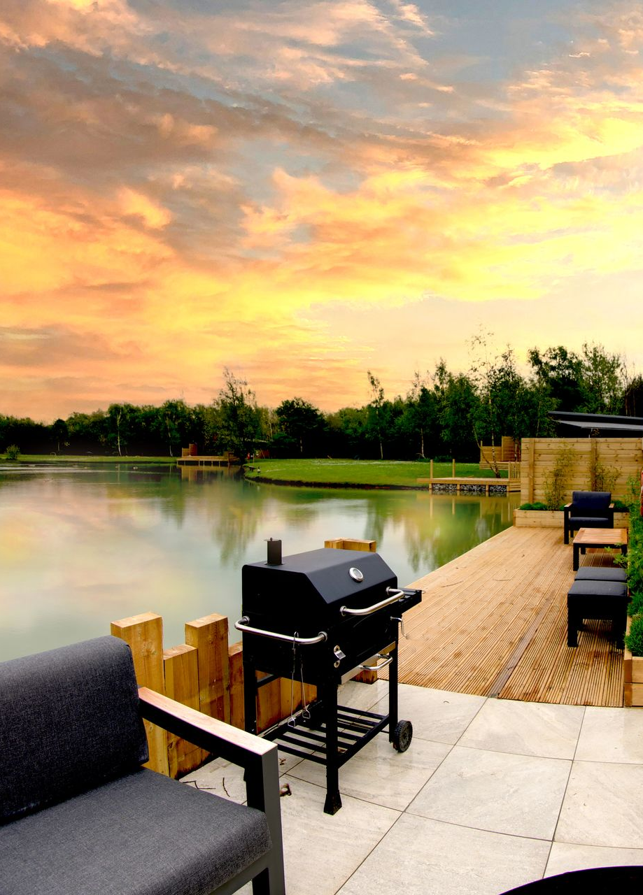 Luxury lodge deck overlooking a lake at golden hour