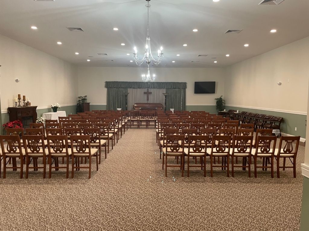 A large room filled with wooden chairs and a chandelier.