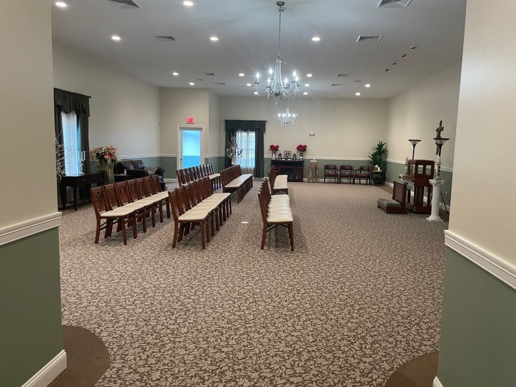 A large room with rows of chairs and benches in it.