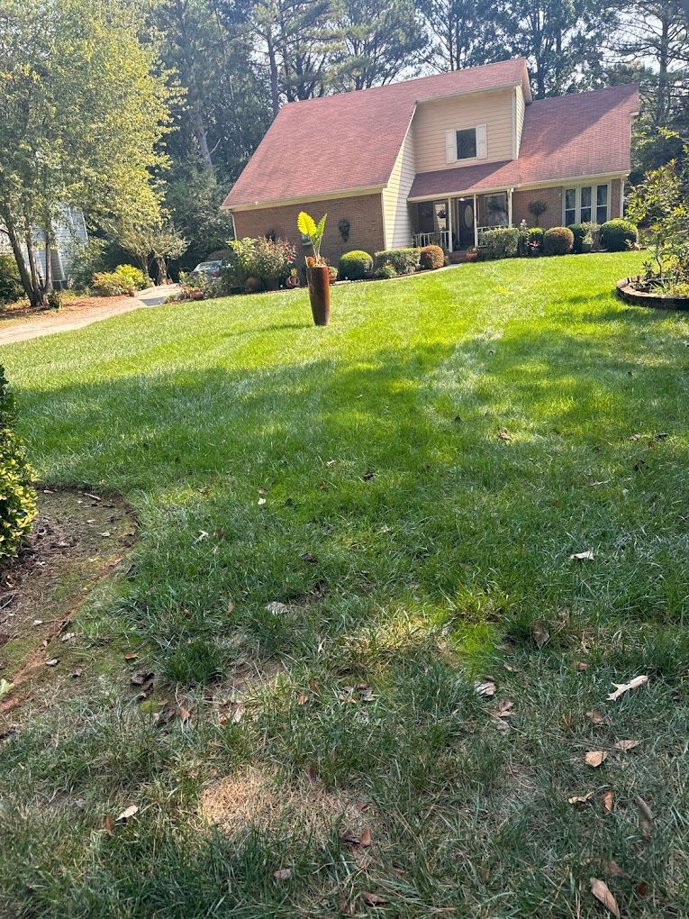 A large house with a lush green lawn in front of it.