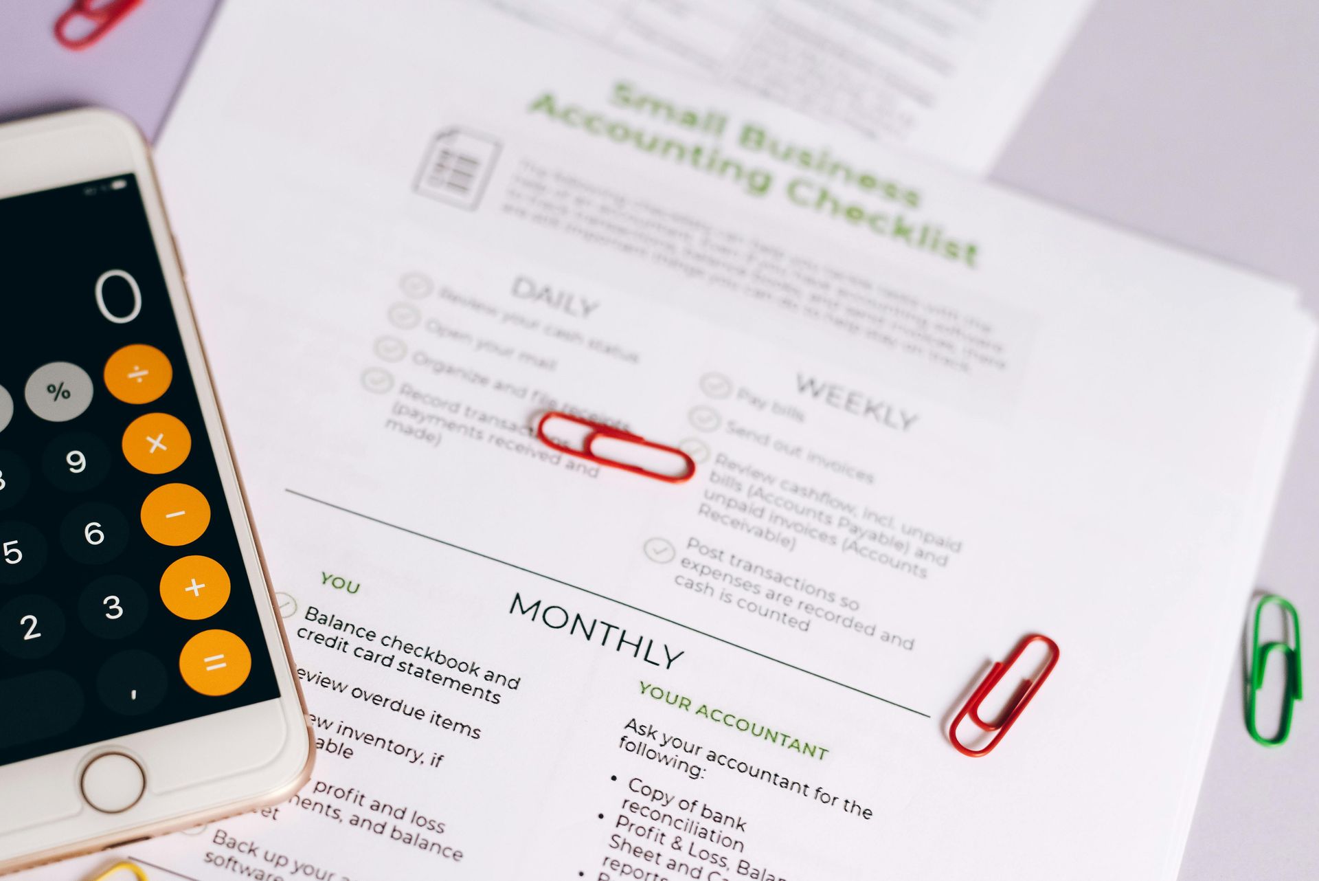 Calculator and financial statements on a desk for mid-year tax planning in Chattanooga, TN