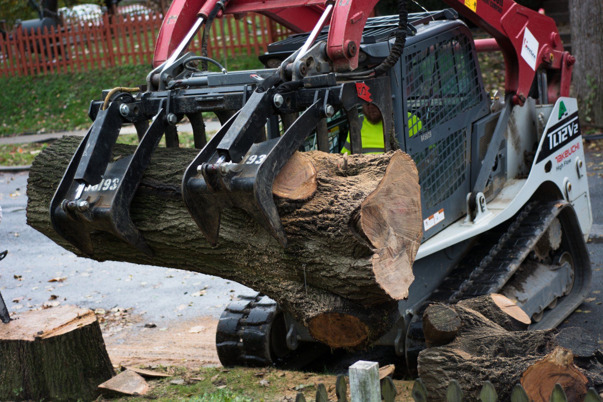 tractor picking up a huge tree trunck