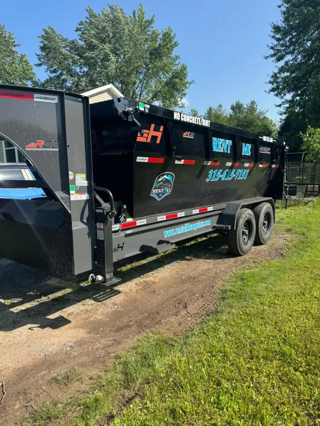 RentAll roll-off trailer carrying a 16-yard dumpster