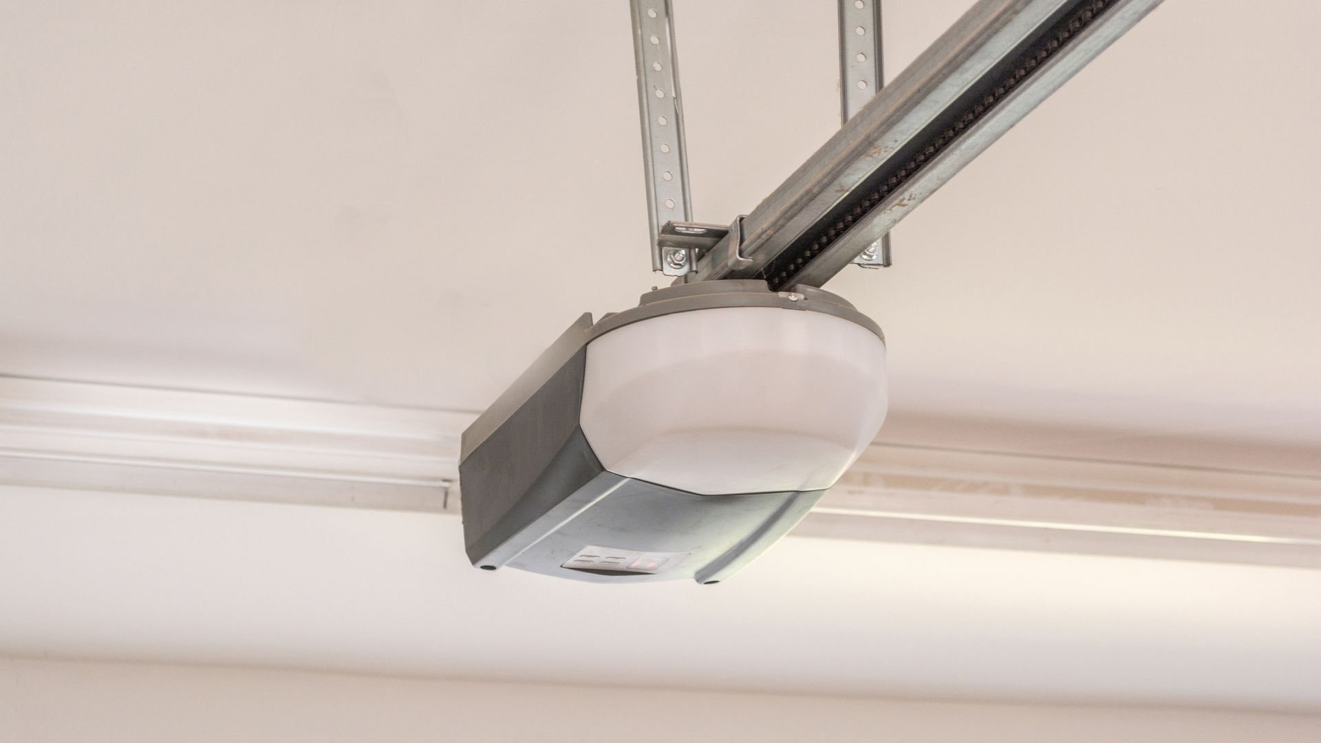 Close-up of a garage door opener featuring a built-in light for improved convenience and safety.