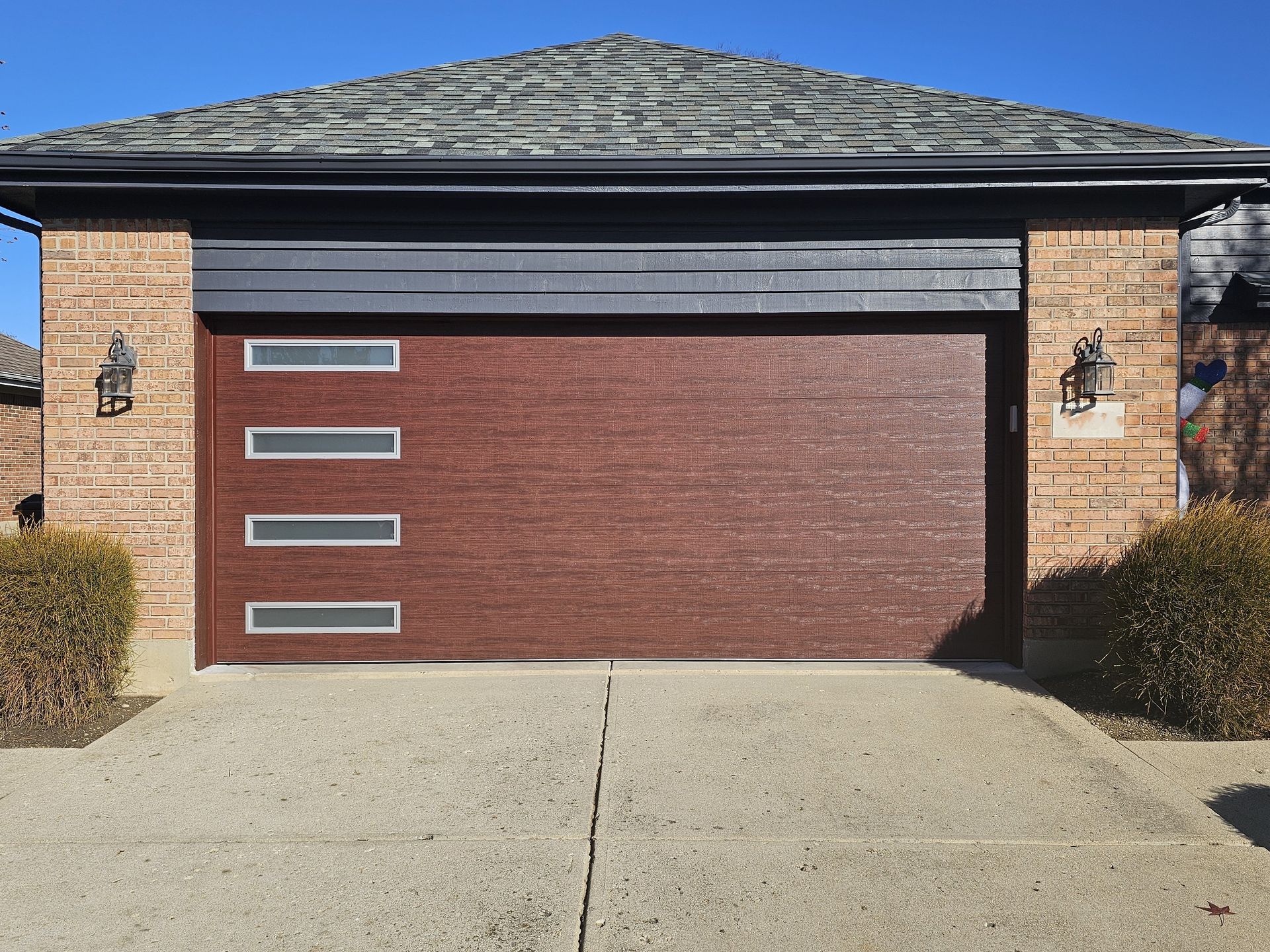 Upgraded tan garage door after replacement
