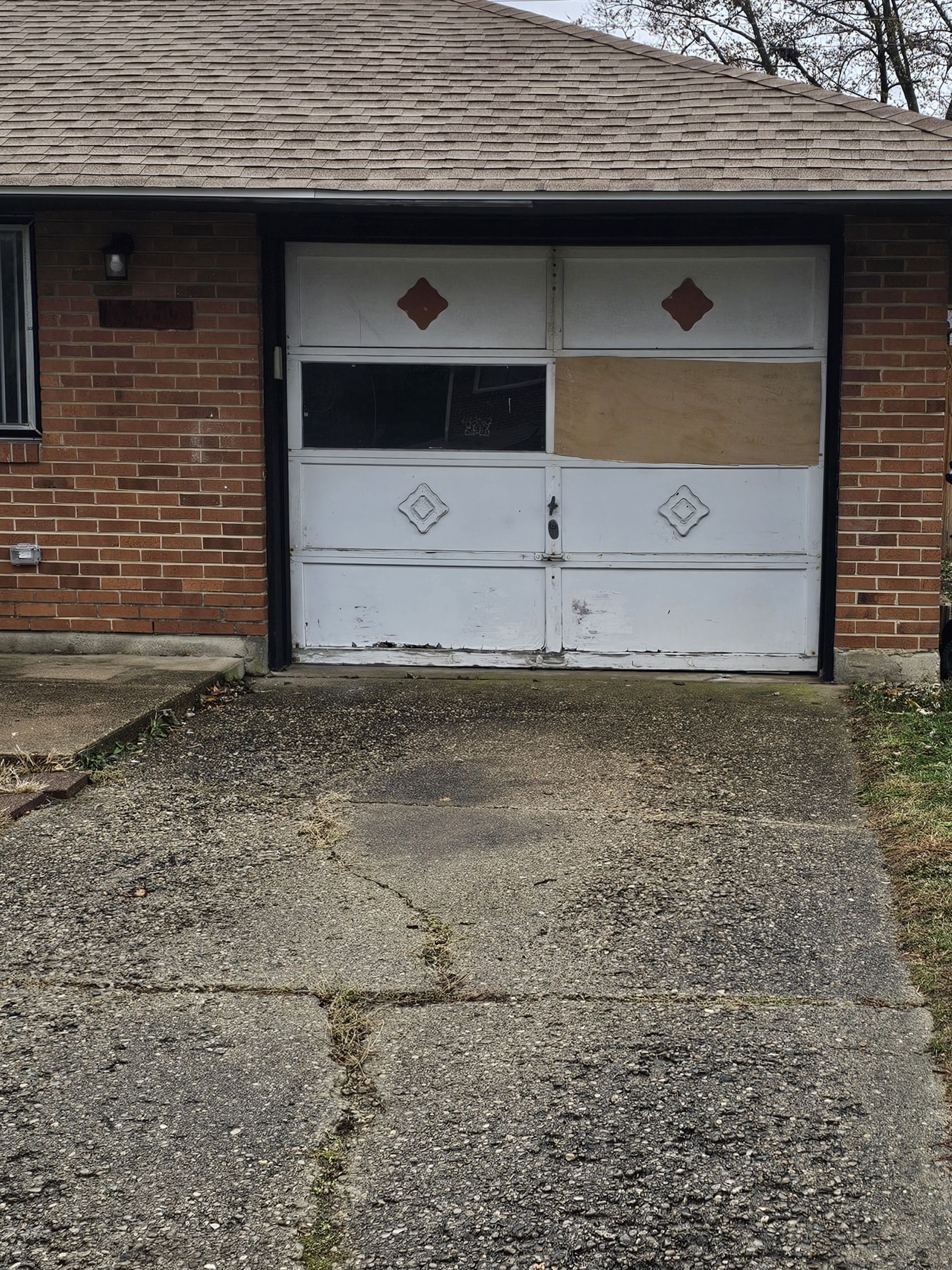 Damaged white garage door
