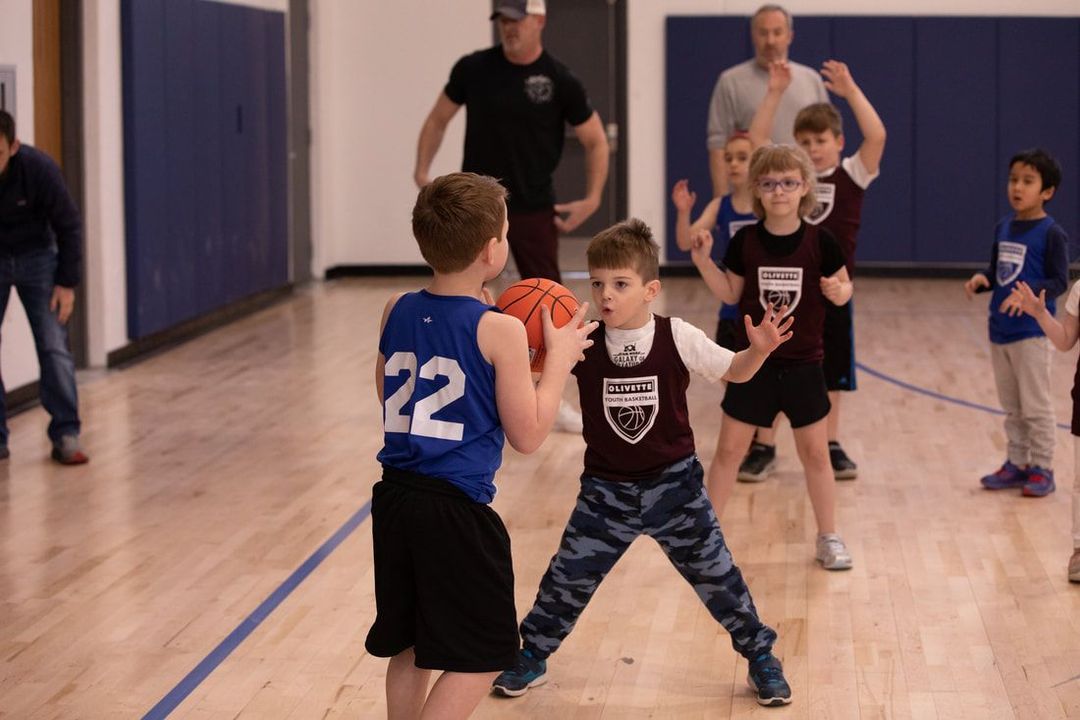 Basketball about to go through a hoop.
