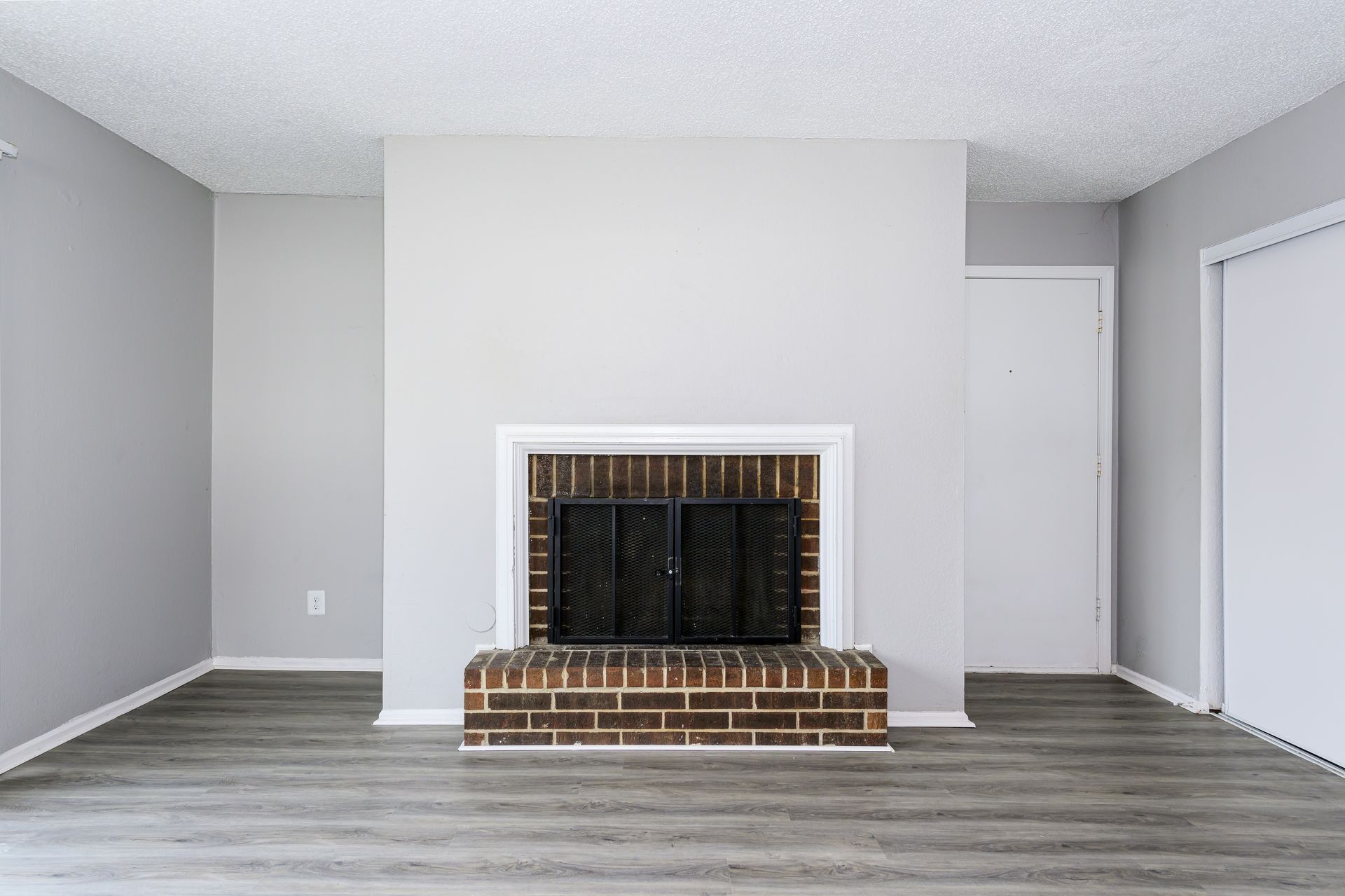There is a fireplace in the middle of the living room.
