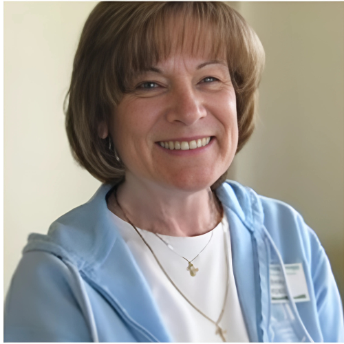 A woman wearing a blue hoodie smiles for the camera