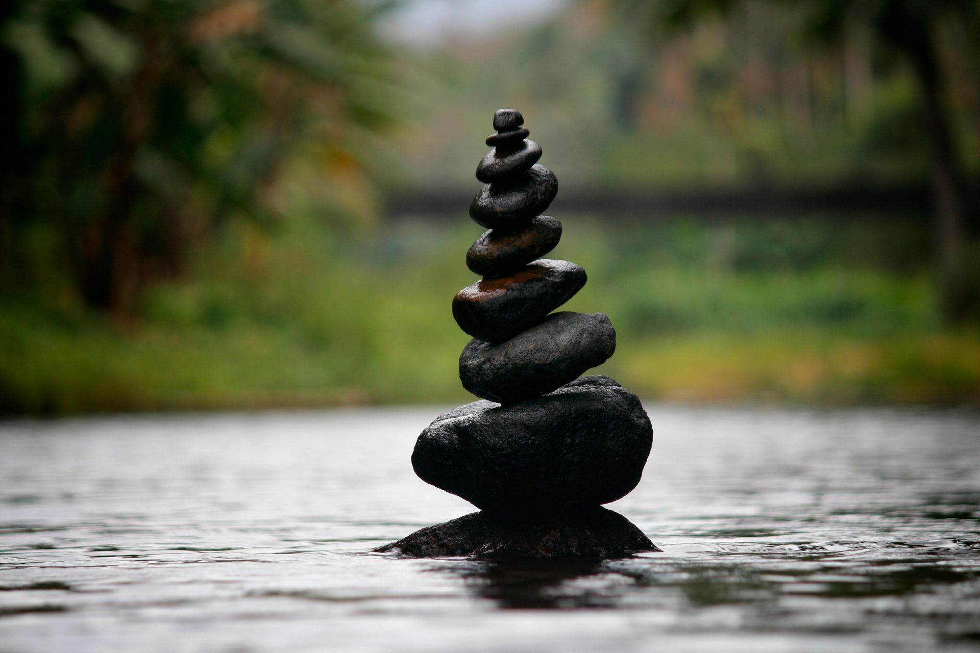 A pile of rocks stacked on top of each other in the water.