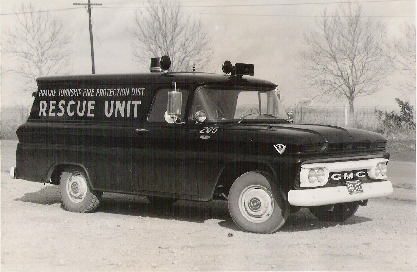 Black GMC rescue unit van parked outdoors in a snowy lot, side view with bold lettering.