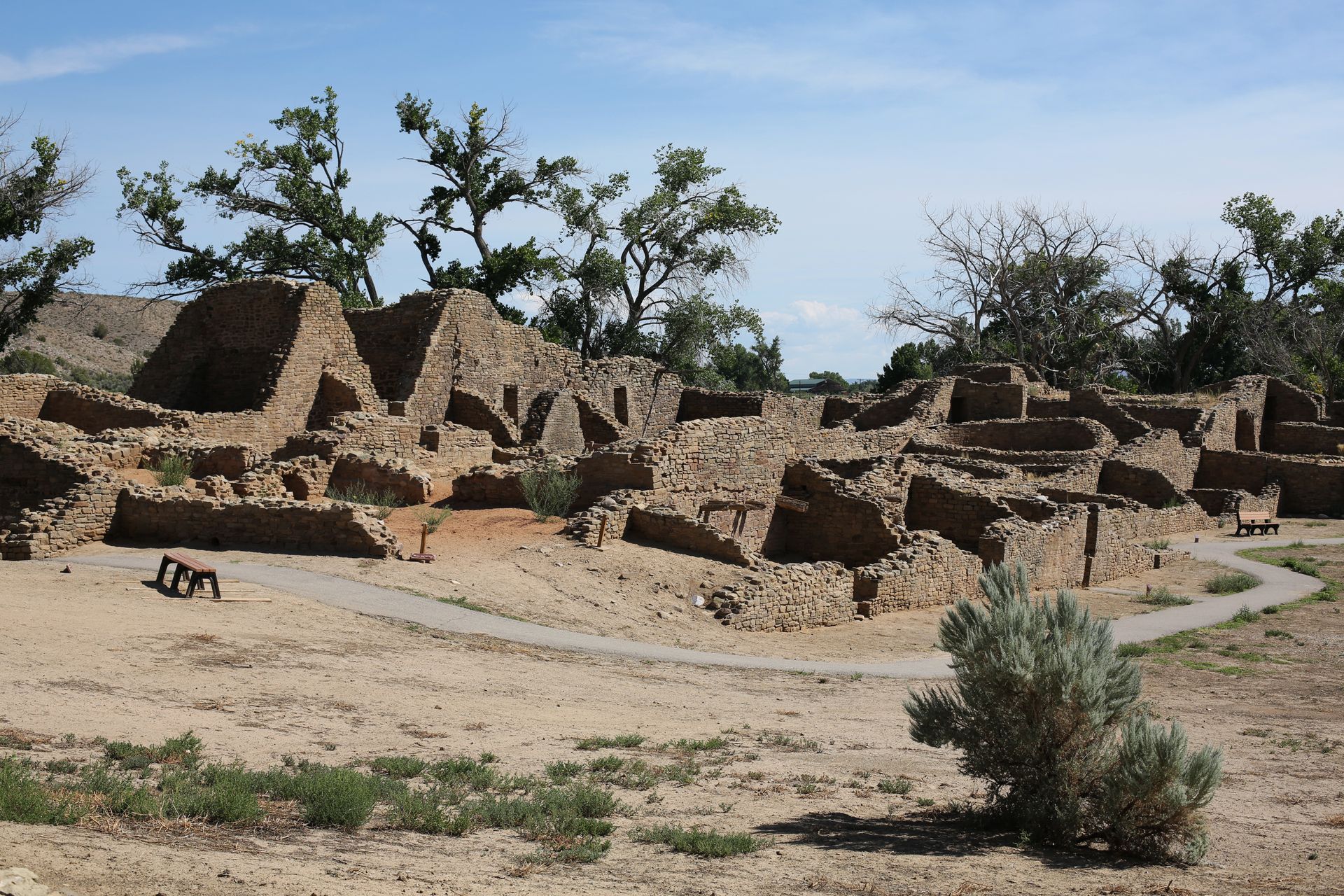 Ruins of an old stone structure in a dry landscape under a blue sky
