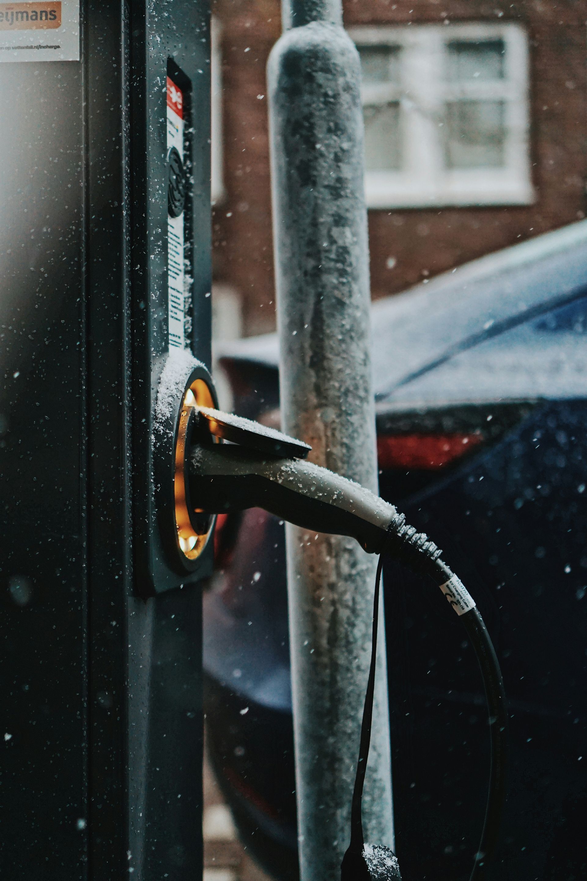 An electric car is being charged at a charging station.
