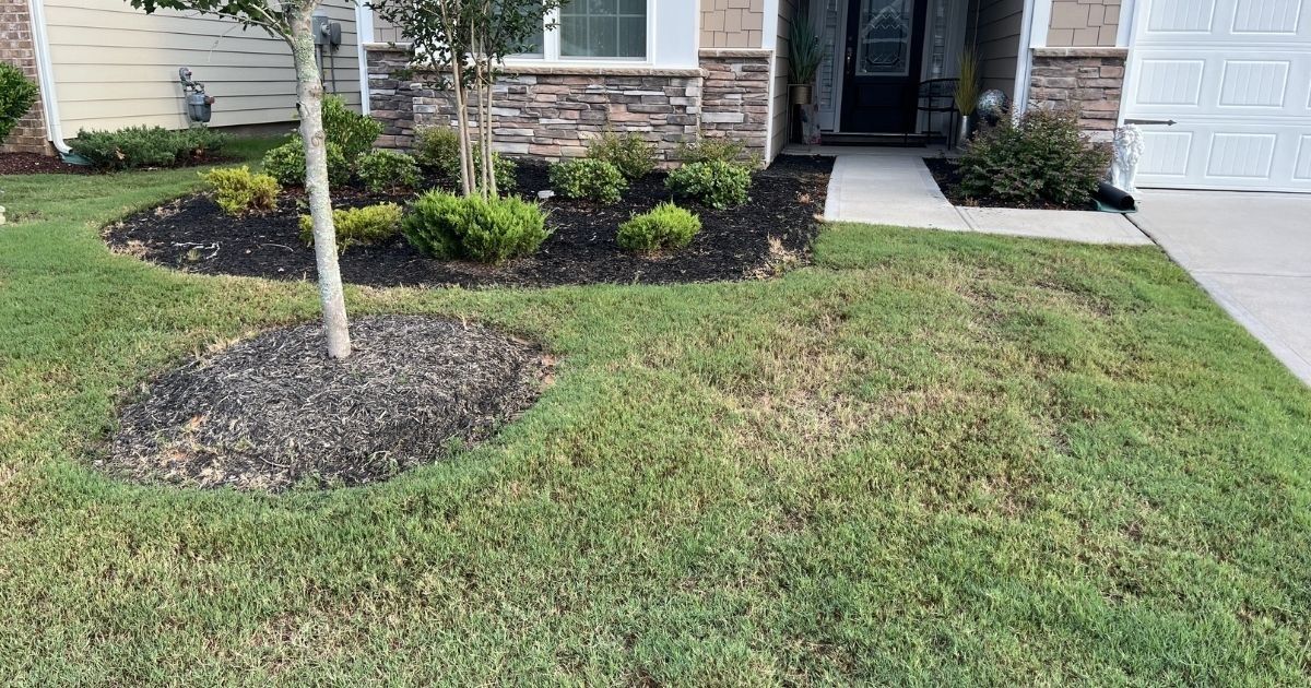 Existing front yard landscape bed before decorative concrete curbing in Tega Cay SC