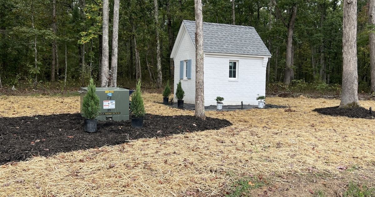 Before photo of well house area before curbing rock and plant installation in Clover SC