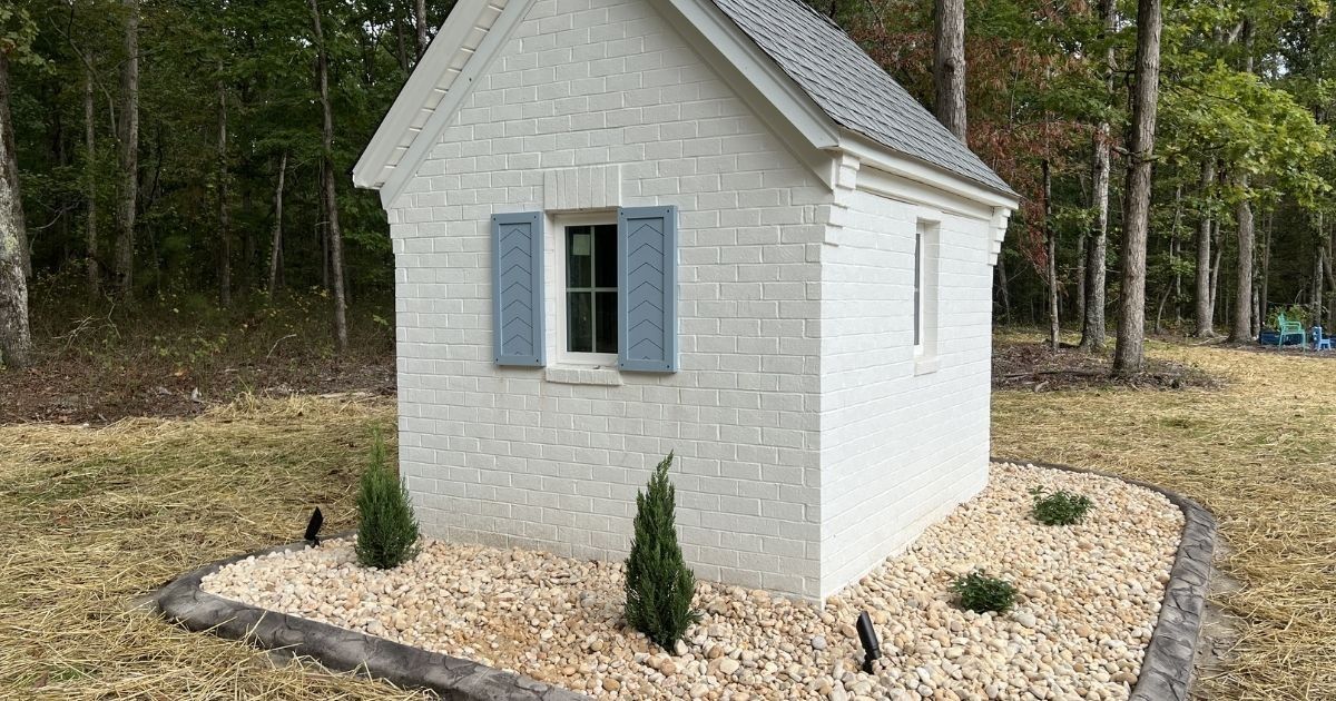 Well house landscaping with river rock decorative curbing and plantings in Clover SC