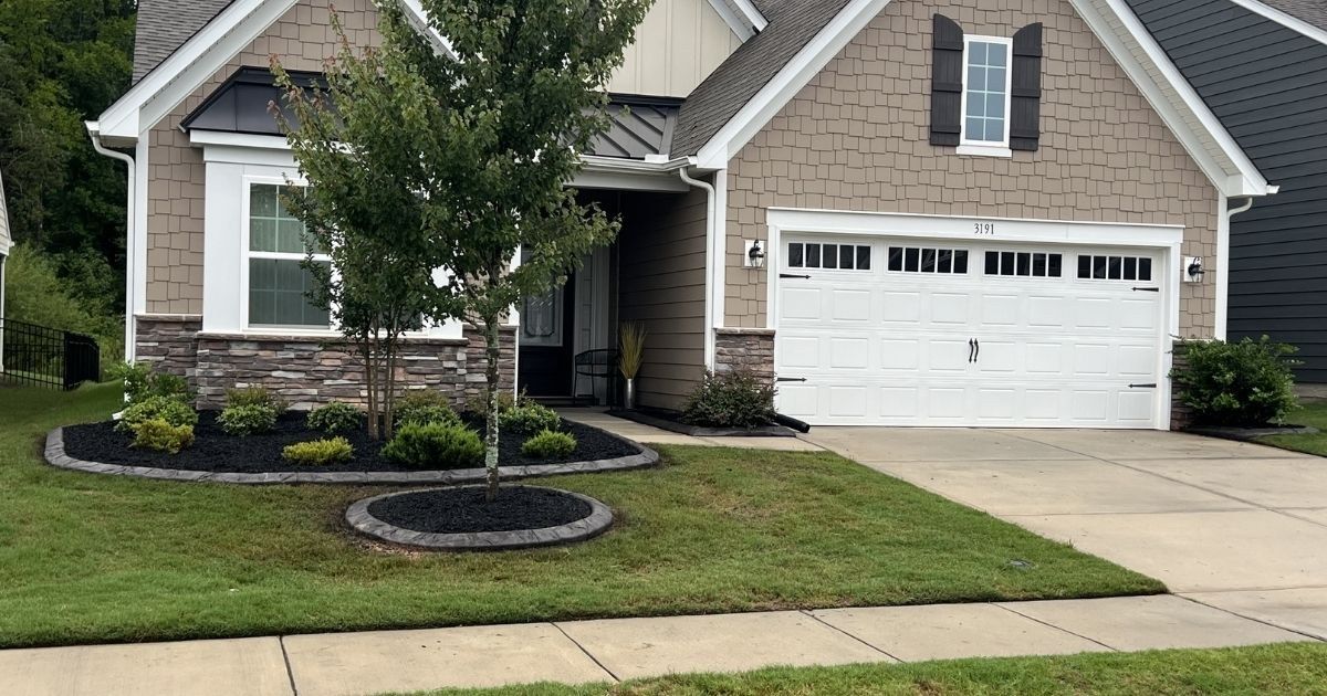 Well house landscaping with river rock decorative curbing and plantings in Clover SC