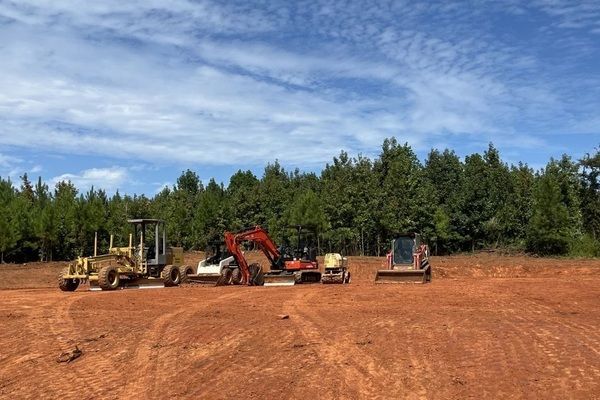 Earth moving equipment in a recently graded feld
