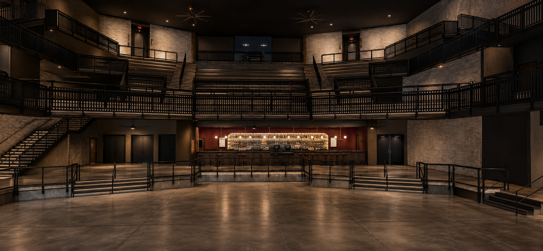 Interior view of a theater stage with tiered seating. Gray and black decor. Empty stage with closed curtains.