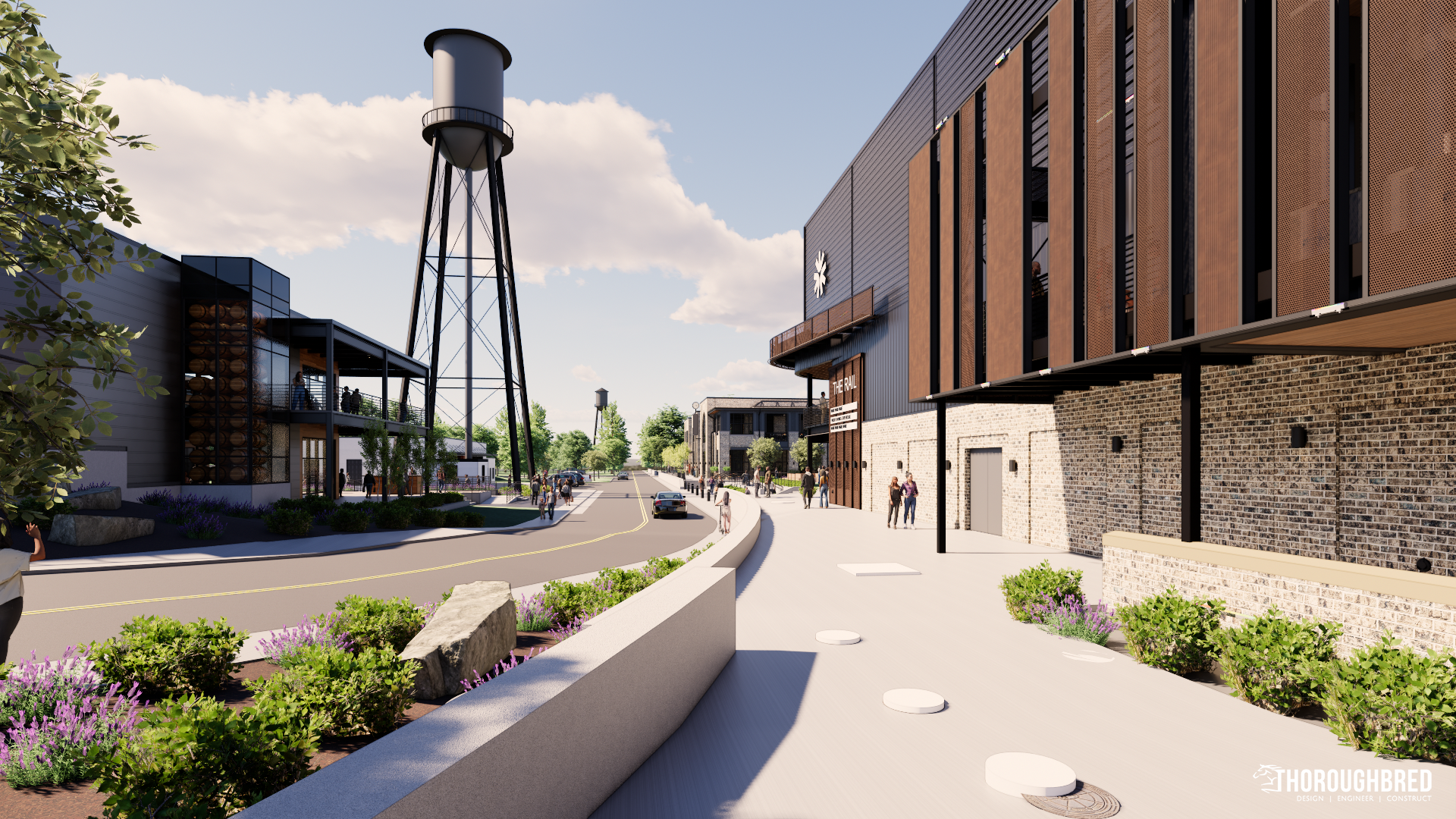Street scene with water tower, modern buildings, and sidewalk with landscaping.