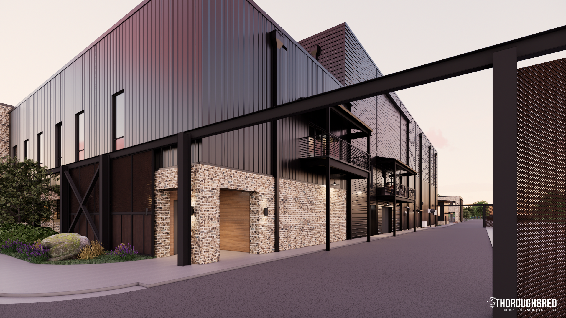Modern building with dark metal siding, stone accents, and a black metal gate.