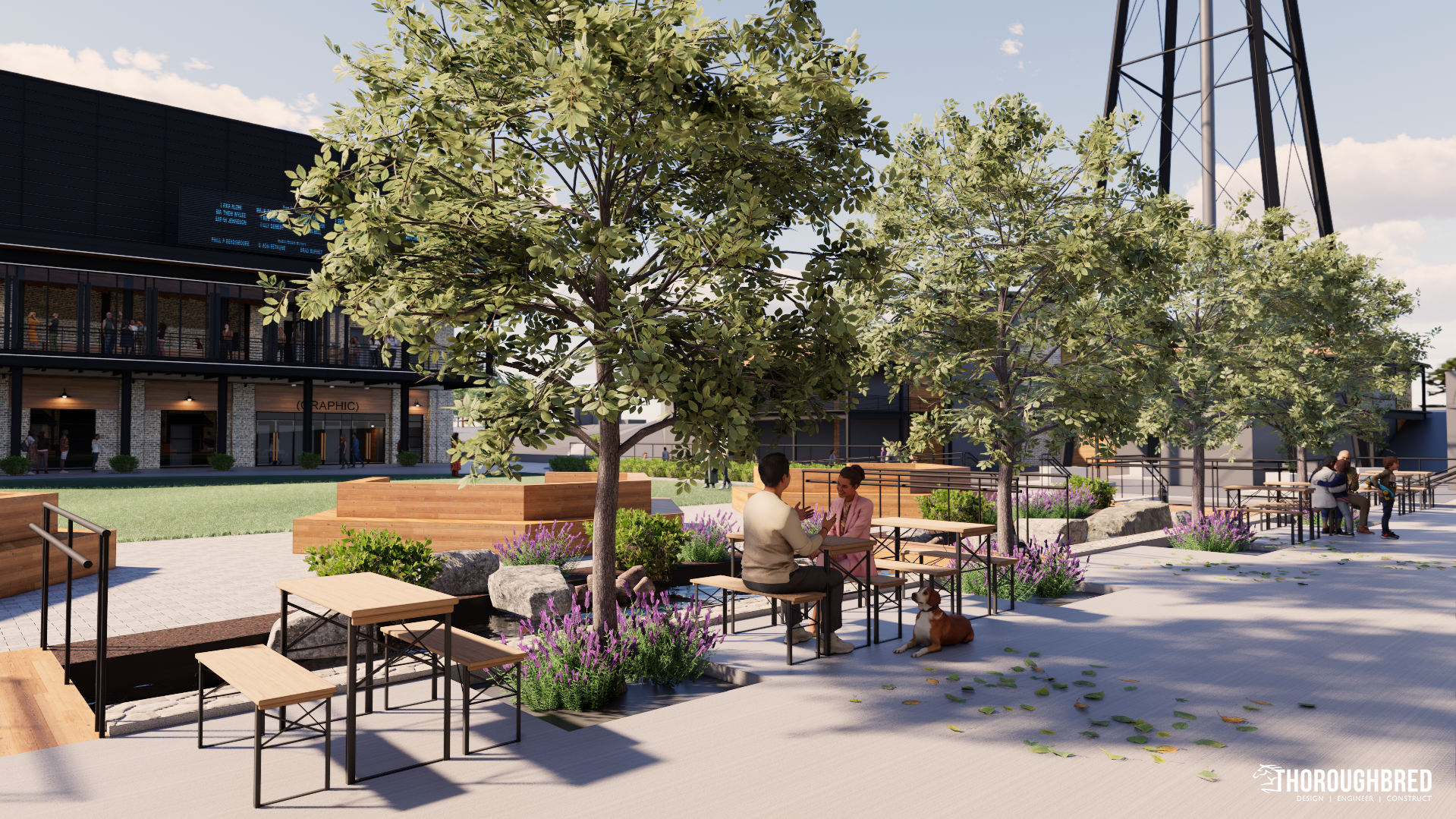 Outdoor plaza with trees, seating, and people dining, near a building and water tower.