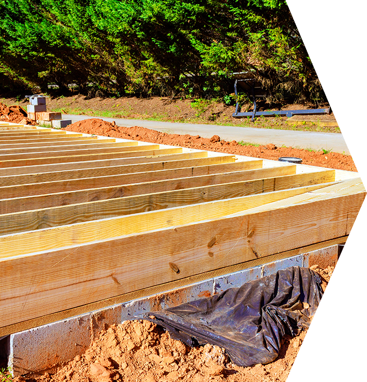 Wooden floor joists and beams under construction on a sunny outdoor build site. Wooden floor joists and beams under construction on a sunny outdoor build site.
