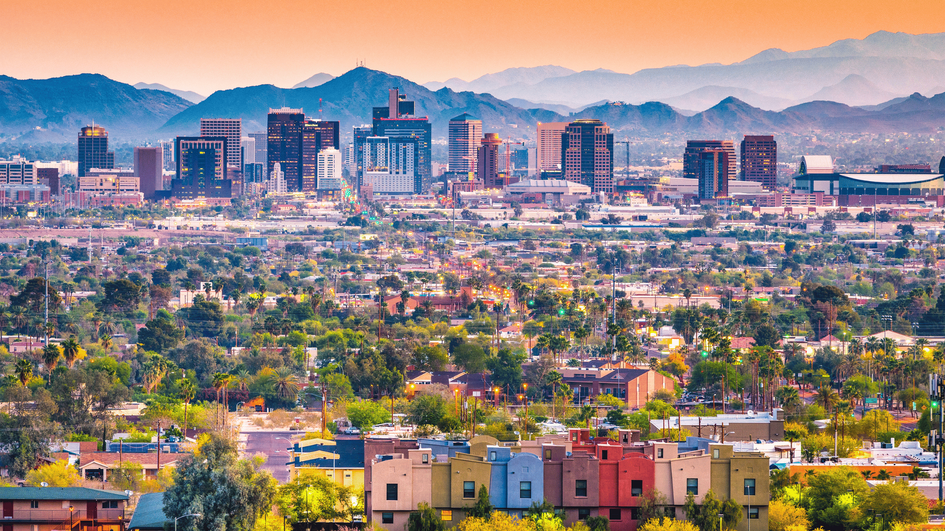 An aerial view of a city with mountains in the background.